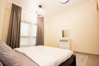 a bedroom with a bed and a window at Brand New 2BHK Fully Furnished Apartment in Warsan in Dubai