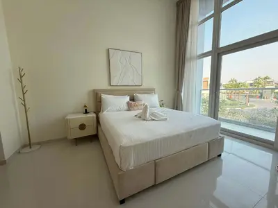 a bedroom with a large bed and a large window at Spacious Fully Furnished 6BR Villa in Damac Hill2 in Dubai