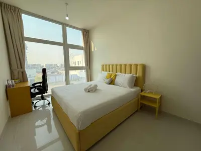 a bedroom with a bed with a stuffed animal on it at Spacious Fully Furnished 6BR Villa in Damac Hill2 in Dubai
