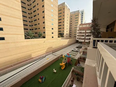 an aerial view of a building with a playground at Stylish & Fully Furnished 1BR in Laya Residence in Dubai