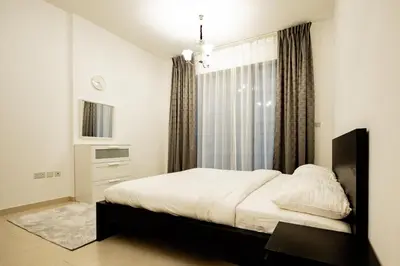 a bedroom with a bed and a window at Newly Furnished 1BHK Apartment in Maya Residency in Dubai