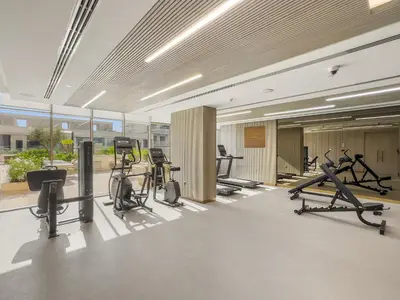 a gym with treadmills and exercise equipment in a building at VayK - Refined 1 BD Apartment in JVC in Dubai