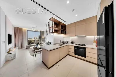 a kitchen with white appliances and a large window at Vida Residences Dubai Mall - Burj Khalifa View, Downtown Dubai in Dubai
