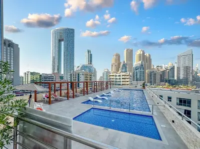 a pool on the roof of a building with a city skyline at Luxury 2BHK with Floating Bed in Dubai Marina DEC1105 in Dubai