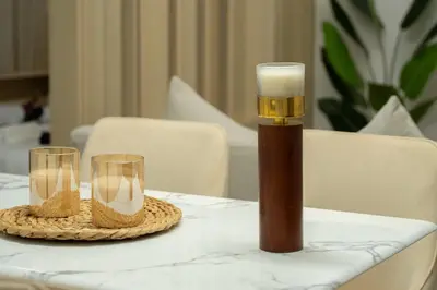 a table with a candle and two glasses on it at Luxury 2BHK with Floating Bed in Dubai Marina DEC1105 in Dubai