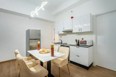 a kitchen with a table and chairs in a room at Luxury 2BHK with Floating Bed in Dubai Marina DEC1105 in Dubai