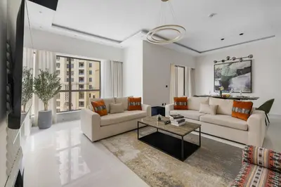 a living room with two couches and a table at 2BR Marina View Steps from the Beach in Dubai