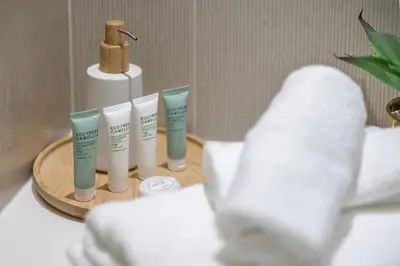 a tray with three tubes of moisturizers and a bottle of toothpaste at 2BR Marina View Steps from the Beach in Dubai