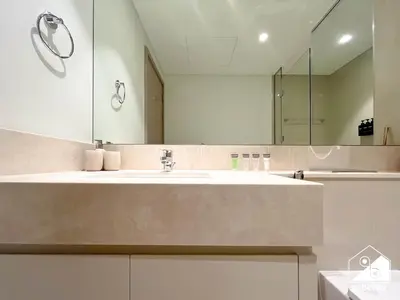 a bathroom with a sink and a mirror at Skyline Escape 2BR Stay with balcony, Pool & Gym in Dubai