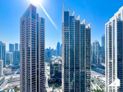 a group of tall buildings in a city at Skyline Escape 2BR Stay with balcony, Pool & Gym in Dubai