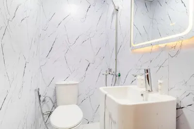 a white bathroom with a toilet and a sink at Luxury 2BR in Dubai Marina Man 1014 in Dubai