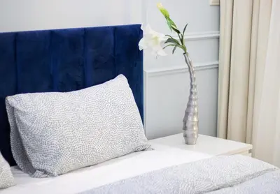 a vase with a white flower sitting on a bed at Luxury 2BR in Dubai Marina Man 1014 in Dubai