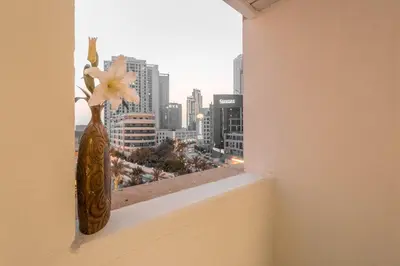a vase on a window sill with a view of a city at Luxury 2BR in Dubai Marina Man 1105 in Dubai