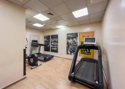 a gym with two treadmills and two exercise bikes at Luxury 2BR in Dubai Marina Man 1105 in Dubai