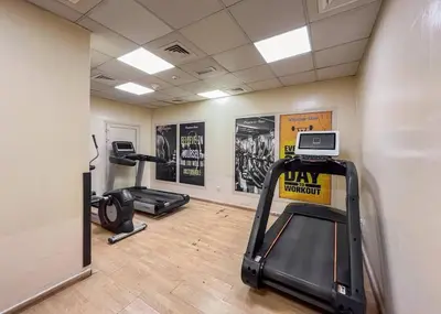 a gym with two treadmills and two exercise bikes at Luxury 3BHK w Floating Bed in Dubai Marina Man 2501 in Dubai