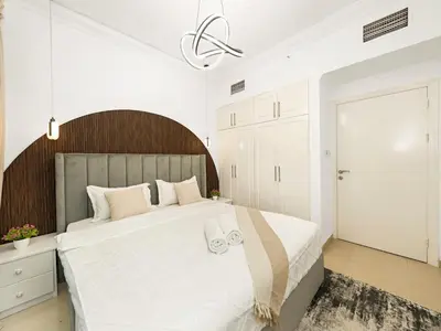a white bedroom with a large bed with white sheets at Luxury 3BHK w Floating Bed in Dubai Marina Man 2501 in Dubai