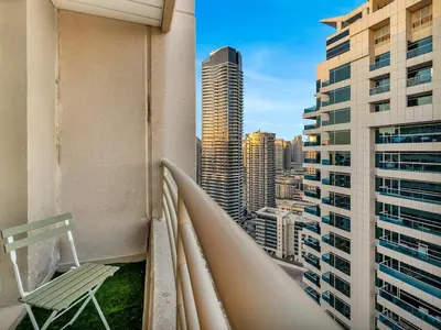 a balcony with a bench and a view of the city at Luxury 3BHK w Floating Bed in Dubai Marina Man 2501 in Dubai