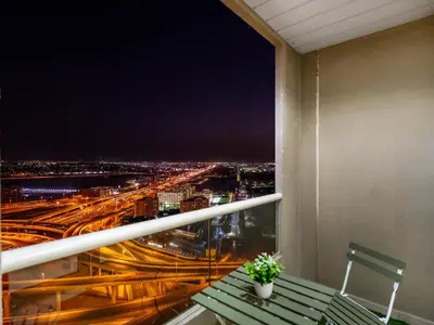 a balcony with a view of a city at night at Luxury 3BHK w Floating Bed in Dubai Marina Man 2501 in Dubai