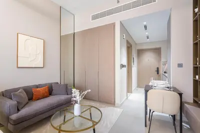 a living room with a couch and a table at Stylish Comfort Studio in Westwood Grande in Dubai