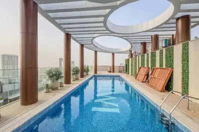 a swimming pool on the roof of a building at Stylish Comfort Studio in Westwood Grande in Dubai