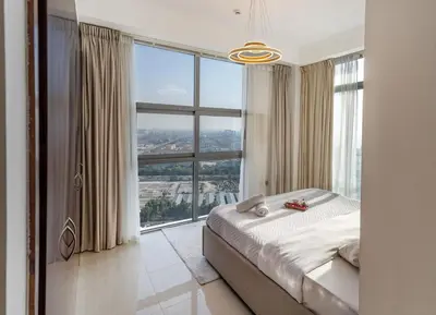a bedroom with a bed and a large window at Luxury 3 BR w Floating Bed in Dubai Marina DEC 902 in Dubai