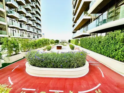 a building with a garden in the middle of it at Chic & Sleek Studio in Westwood Grande in Dubai