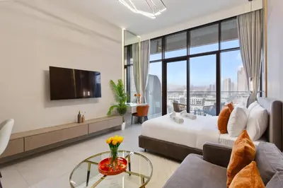 a hotel room with a bed and a tv at Chic & Sleek Studio in Westwood Grande in Dubai