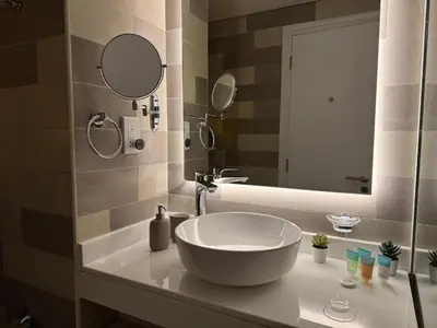 a bathroom with a large white bowl sink on a counter at Comfortable apartments on the Palm in Dubai