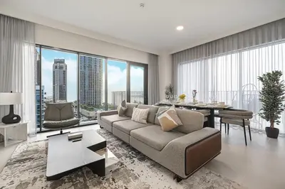 a living room with a couch and a table at Luxury 3 Bedroom Apartment in Creek Harbour in Dubai