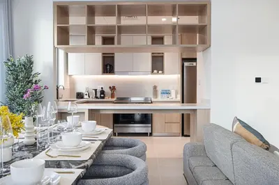 a kitchen and living room with a couch and a table at Luxury 3 Bedroom Apartment in Creek Harbour in Dubai