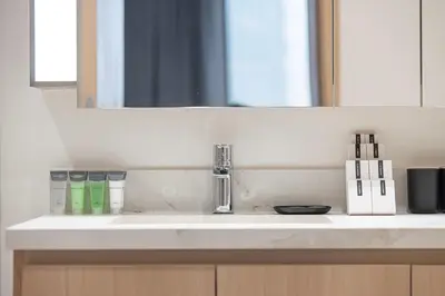a bathroom counter with a sink and a mirror at Luxury 3 Bedroom Apartment in Creek Harbour in Dubai