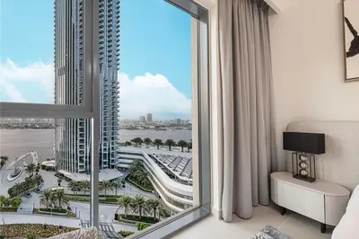 a room with a large window with a view of a city at Luxury 3 Bedroom Apartment in Creek Harbour in Dubai