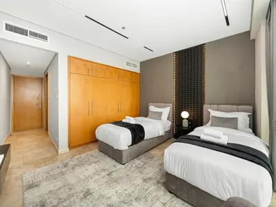 two beds in a large room with at MegaLuxury Beachfront with Panoramic Ain Dubai Views in JBR, Sleep 12 in Dubai