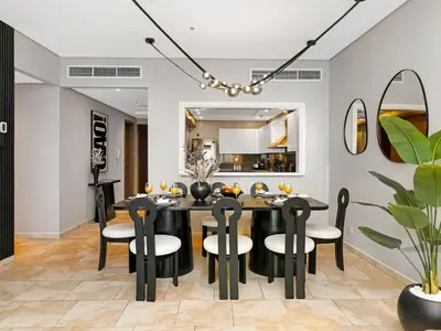 a dining room with a black table and chairs at MegaLuxury Beachfront with Panoramic Ain Dubai Views in JBR, Sleep 12 in Dubai