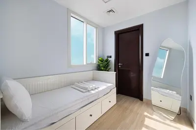 a white room with a bed and a mirror at Luxury 5BR Marina View w Private Pool KG1004 in Dubai