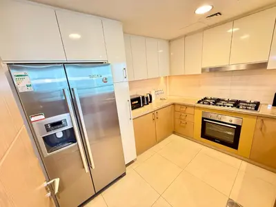 a large kitchen with a stainless steel refrigerator at Nivis find-3BHK Apartment-Burj vista- Connected to Dubai Mall in Dubai