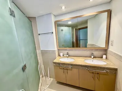 a bathroom with two sinks and a shower at Nivis find-3BHK Apartment-Burj vista- Connected to Dubai Mall in Dubai