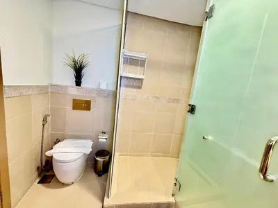 a bathroom with a toilet and a glass shower at Nivis find-3BHK Apartment-Burj vista- Connected to Dubai Mall in Dubai