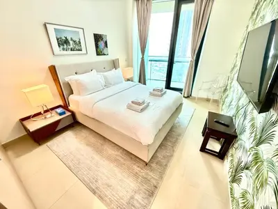 a bedroom with a bed and a large window at Nivis find-3BHK Apartment-Burj vista- Connected to Dubai Mall in Dubai