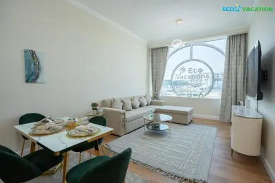 a living room with a couch and a table at Eco-Luxe Retreat - Minutes from Global Village in Dubai