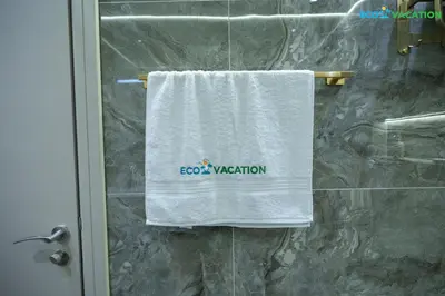 a towel hanging on a shower door in a bathroom at Eco-Luxe Retreat - Minutes from Global Village in Dubai