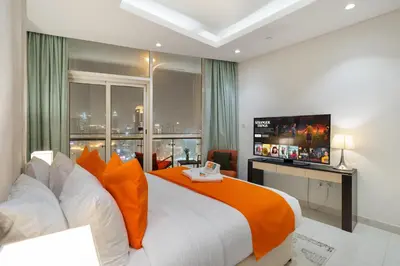 a bedroom with a large bed and a television at Full Burj Khalifa View New Year Fireworks - DAMAC Maison Distinction in Dubai
