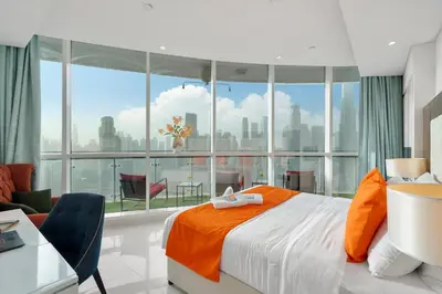 a bedroom with a bed and a large window at Full Burj Khalifa View New Year Fireworks - DAMAC Maison Distinction in Dubai
