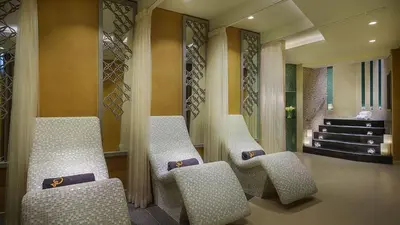 a lobby with three chairs and a staircase in a building at Full Burj Khalifa View New Year Fireworks - DAMAC Maison Distinction in Dubai