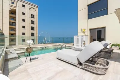 a view of the pool from the balcony of a building at Stunning VIP Penthouse JBR cinema&spa&pool in Dubai
