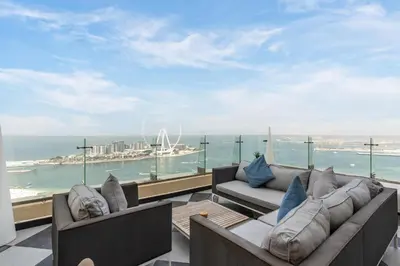 a balcony with couches and a view of the ocean at Stunning VIP Penthouse JBR cinema&spa&pool in Dubai