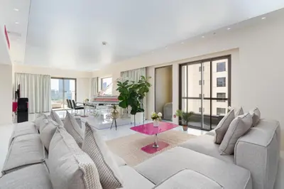 a living room with a large couch and a table at Stunning VIP Penthouse JBR cinema&spa&pool in Dubai