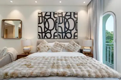 a bedroom with a large bed and a window at White Sage Discovery Gardens Renovated Studio next to Metro in Dubai