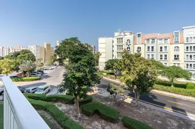 a view of a city street with trees and buildings at White Sage Discovery Gardens Renovated Studio next to Metro in Dubai