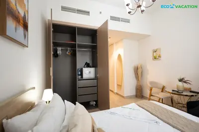 a bedroom with a bed and a table and a chair at Riviera Haven Boutique Stay with Wooden Charm in Dubai